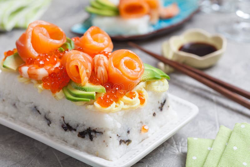 Salmon Sushi Cake. With shrimp, red caviar and avocado stock images