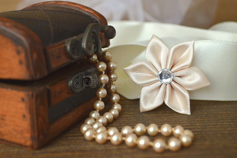 Silk kanzashi flower and pearls. Wedding accessories: silk kanzashi flower and pearls stock photos