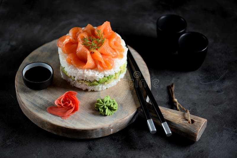Sushi cake with lightly salted salmon, nori and avocado. Food stock image