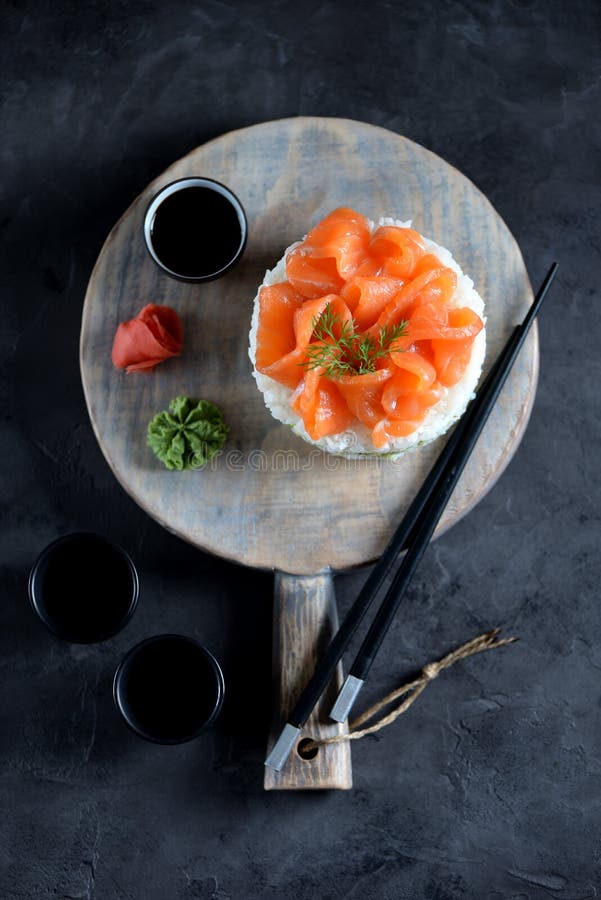 Sushi cake with lightly salted salmon, nori and avocado. Food royalty free stock image
