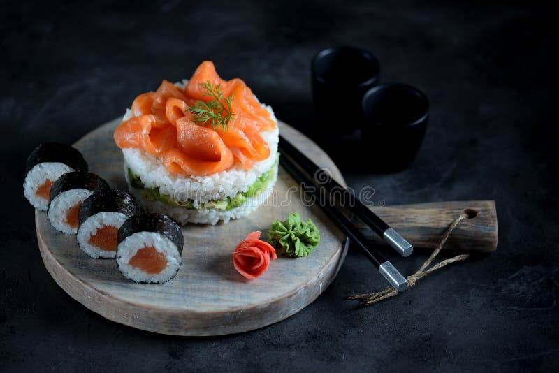 Sushi cake with lightly salted salmon, nori and avocado. Food royalty free stock photo