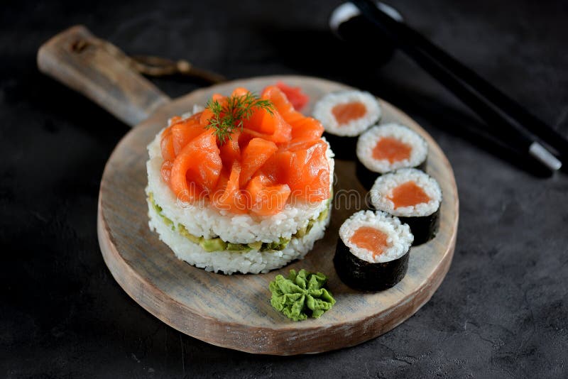 Sushi cake with lightly salted salmon, nori and avocado. Food royalty free stock photos