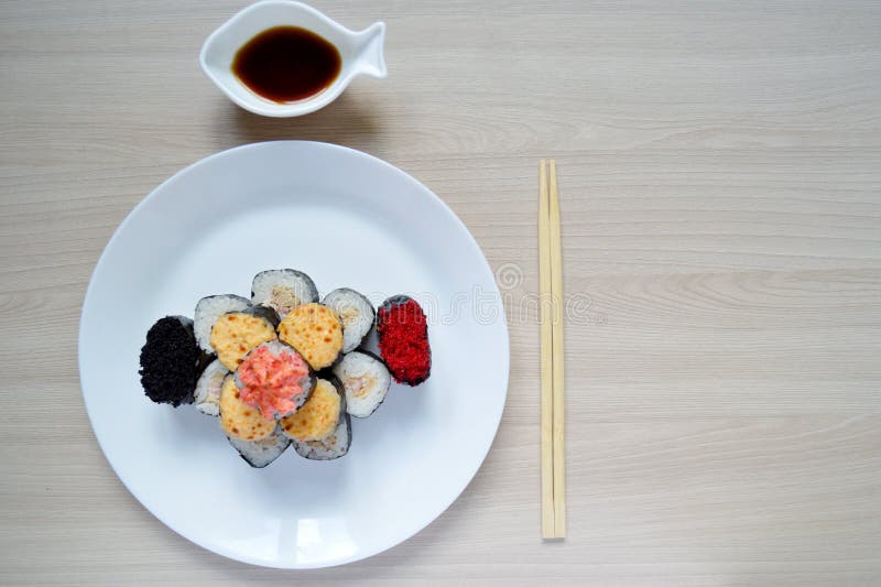 Rolls and sushi folded in the form of a cake on a white plate. Sushi set on a white plate. Rolls and sushi folded in the form of a cake on a white plate stock images