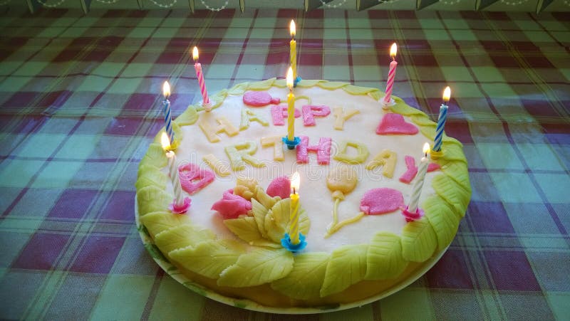 Birthday cake with candles and leaves royalty free stock images