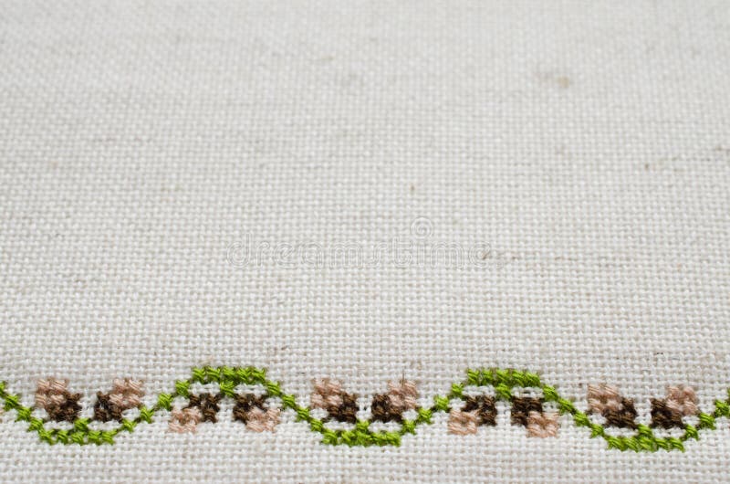 Texture of Beige Linen Fabric with Embroidery. Handmade Embroidery by Cross Stitch in the View of Acorns. Texture of Beige Natural Linen Fabric with Embroidery stock images