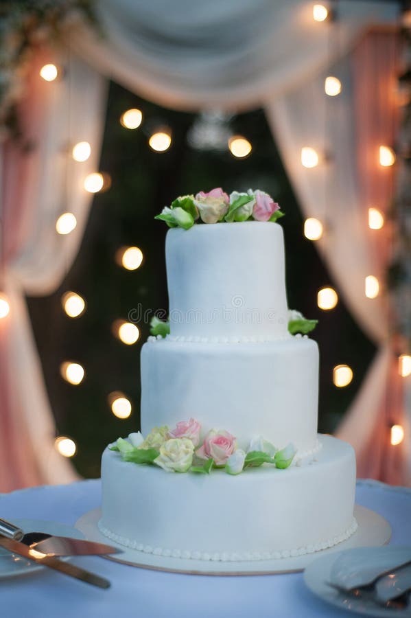 Wedding cake stands on a table with a white tablecloth royalty free stock photography