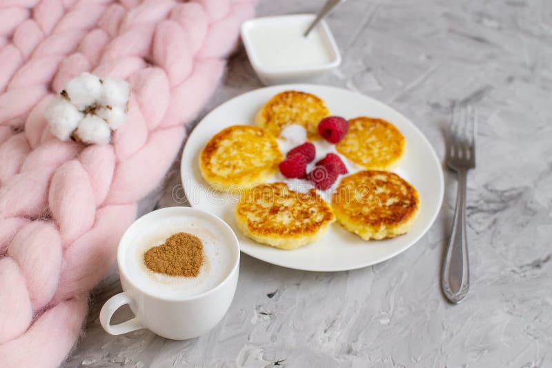 White Cup of Coffee Cappuccino with Heart Pattern of Cinnamon, Cottage Cheese Pancakes with Raspberries. Healthy Breakfast, Traditional Food Valentines day stock images
