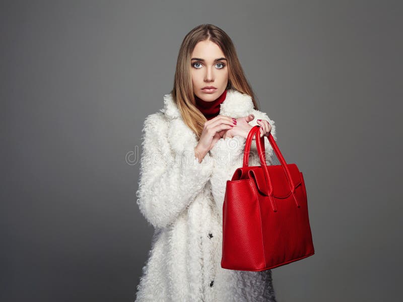 Winter beautiful Woman with red Handbag. Beauty Fashion Model Girl in fur royalty free stock photo