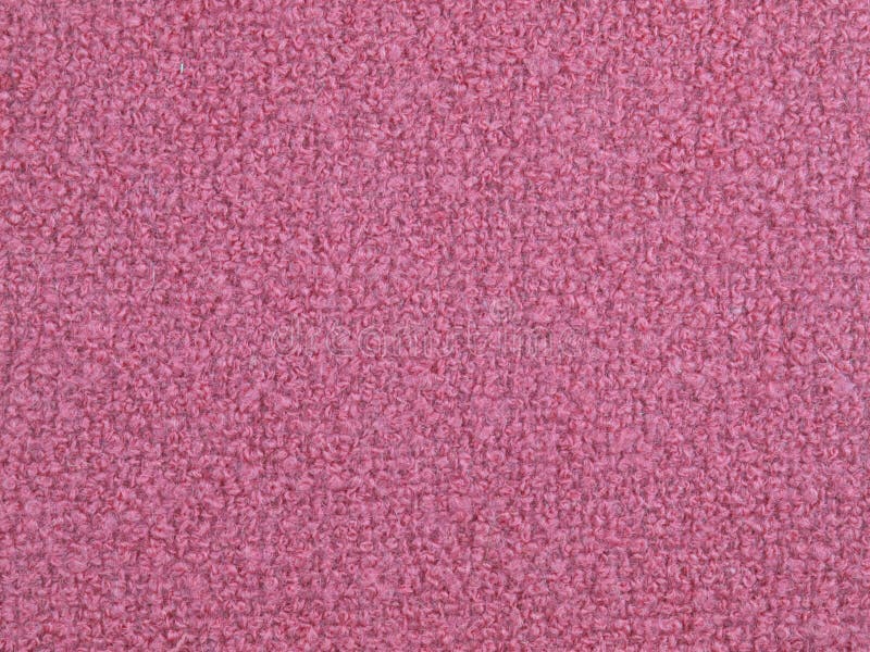 Woven boucle fabric. Pink woolen woven boucle fabric royalty free stock image