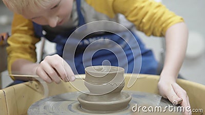 A child decorates a clay vase stock video