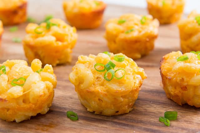 Mac and Cheese Bites on a Wooden Board with Green Onion