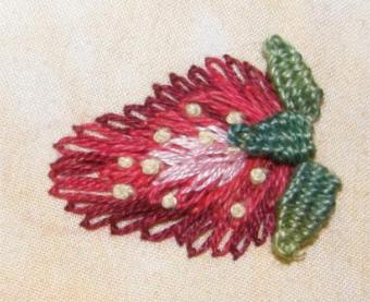A strawberry worked in lazy daisy stitch