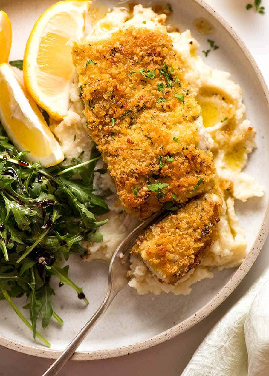 Overhead photo of Parmesan Crumbed Fish (easy baked fish recipe) on a plate, ready to be eaten