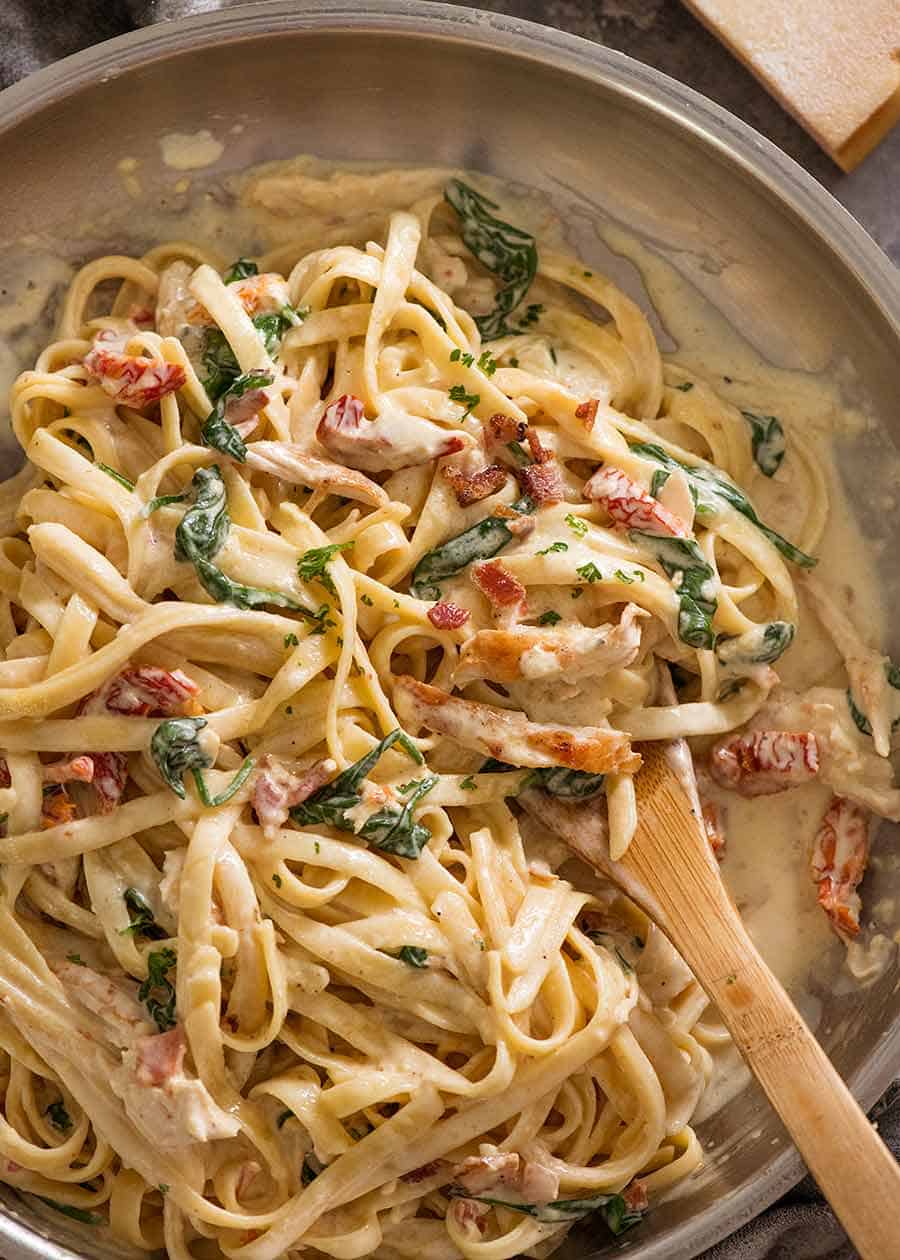 Overhead photo of Chicken Alfredo Pasta with sun dried tomato, spinach and bacon